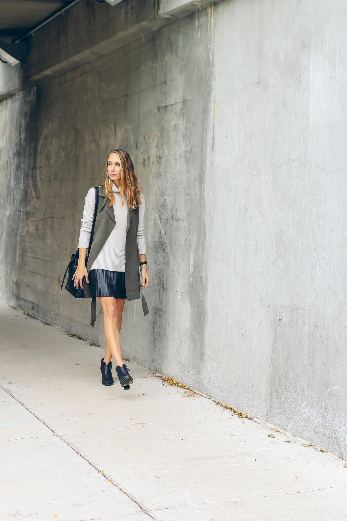 trench vest, pleated leather skirt, chunky knit sweater — via @TheFoxandShe