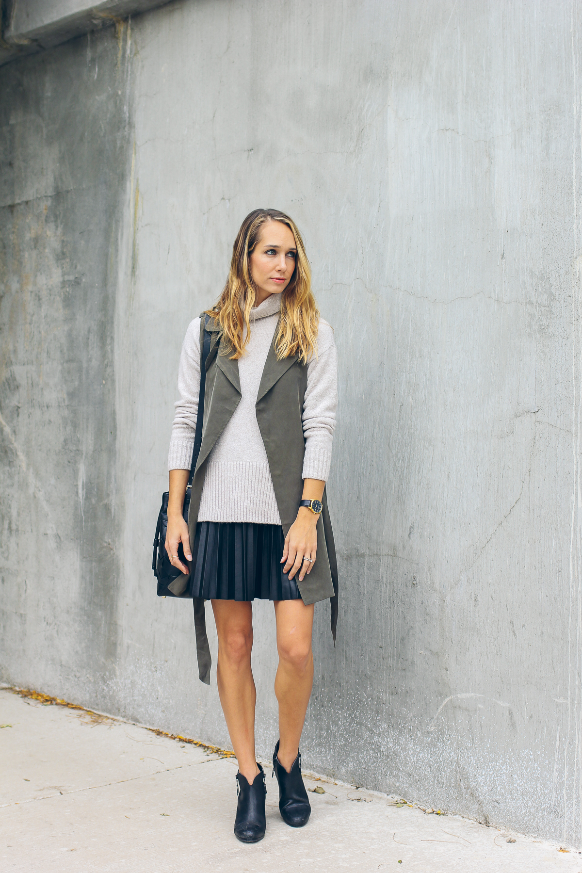 trench vest, pleated leather skirt, chunky knit sweater — via @TheFoxandShe