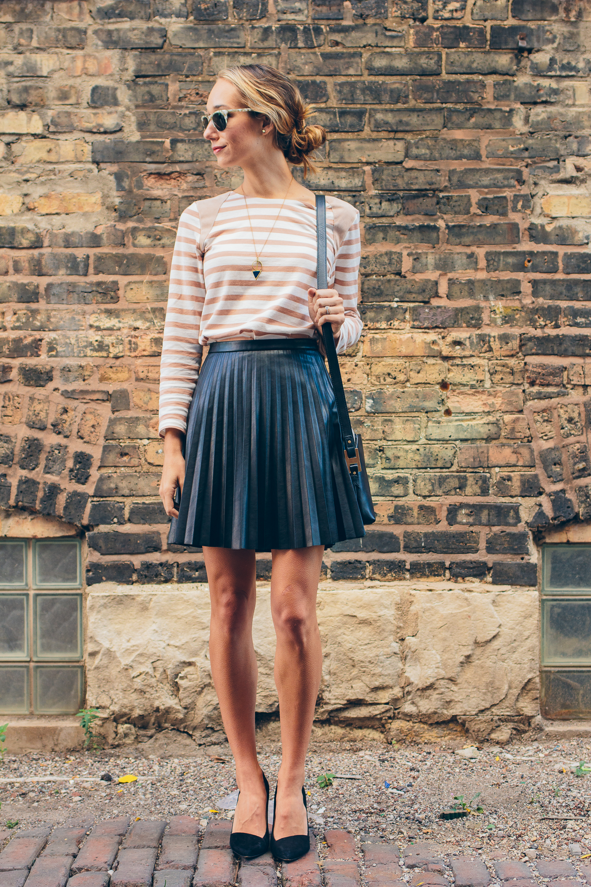 striped tee, pleated leather skirt, india hicks crossbody — via @TheFoxandShe