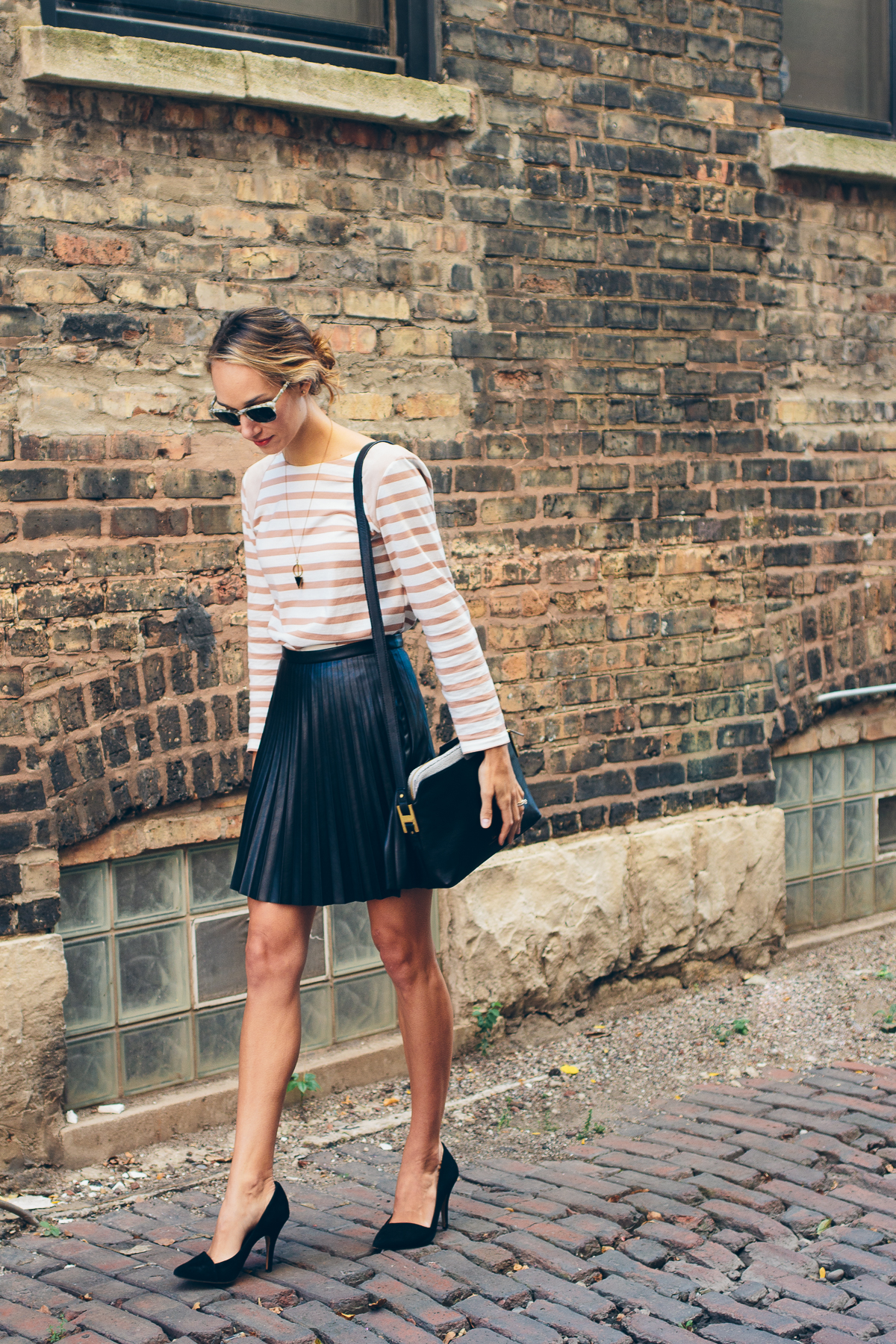 striped tee, pleated leather skirt, india hicks crossbody — via @TheFoxandShe