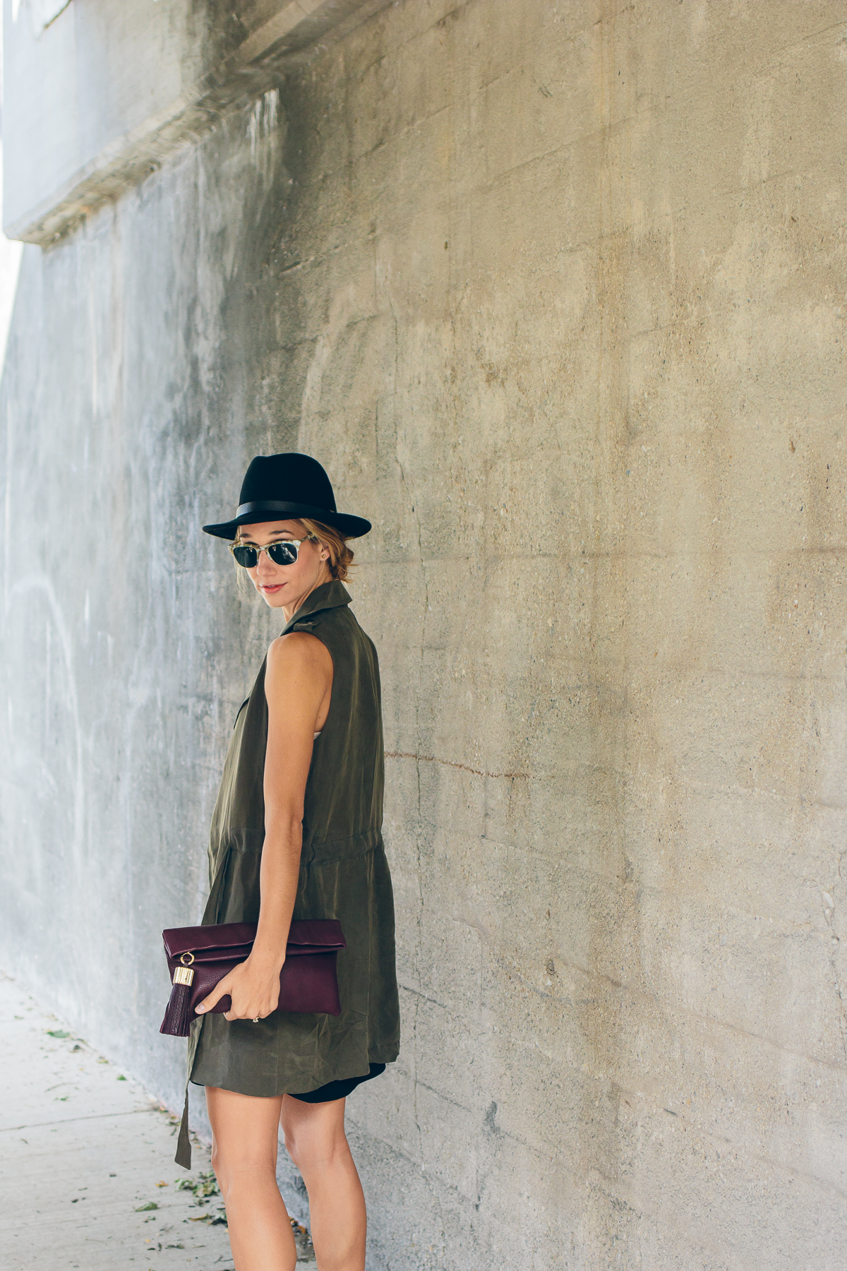 trench vest, wool hat, carmen clutch with tassel detail — via @TheFoxandShe