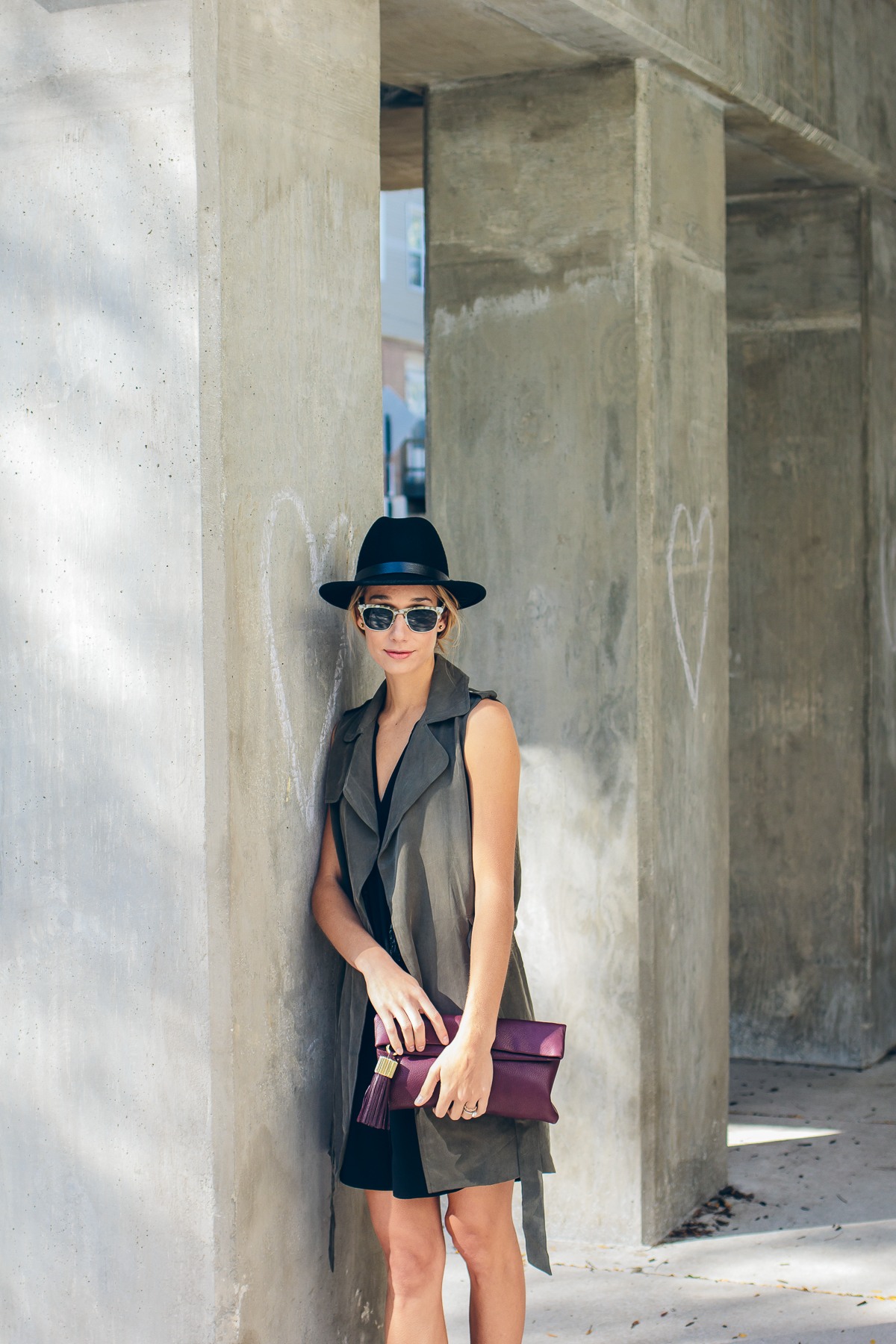 trench vest, wool hat, carmen clutch with tassel detail — via @TheFoxandShe