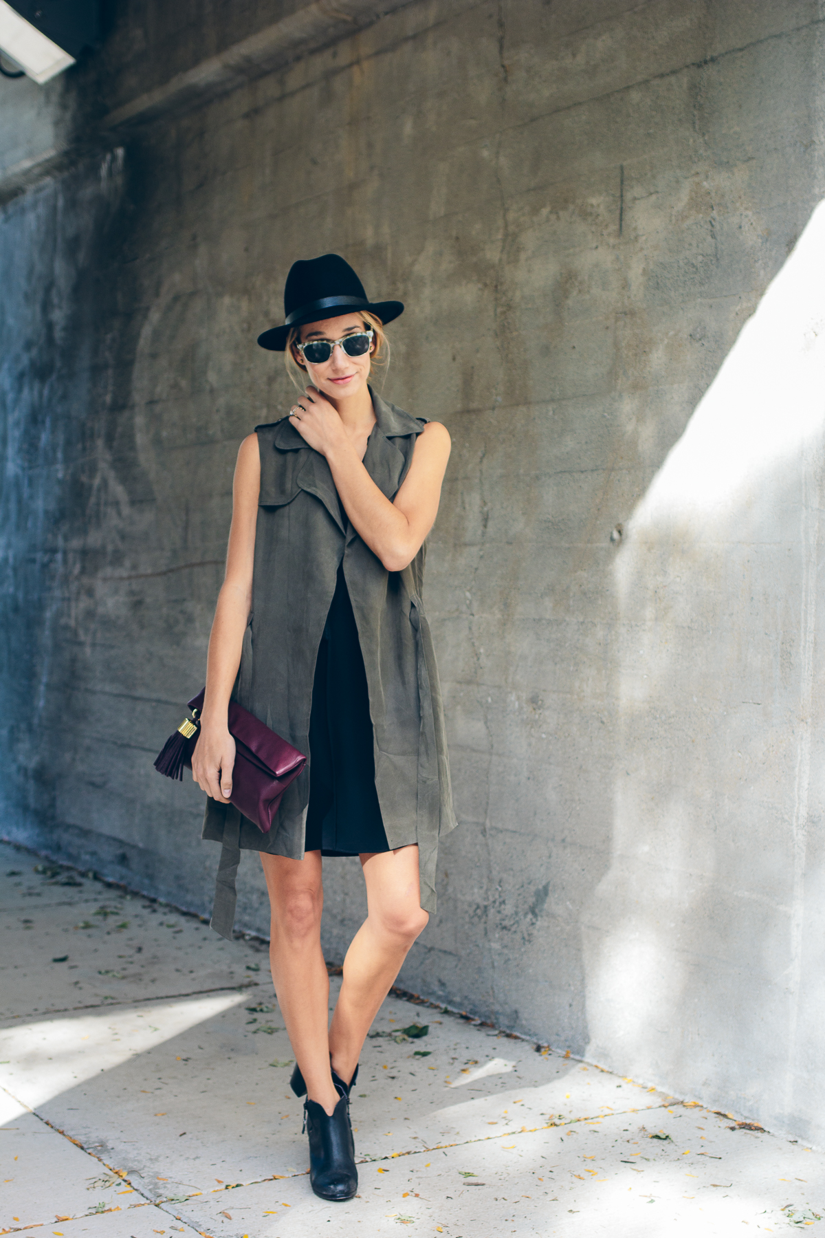 trench vest, wool hat, carmen clutch with tassel detail — via @TheFoxandShe