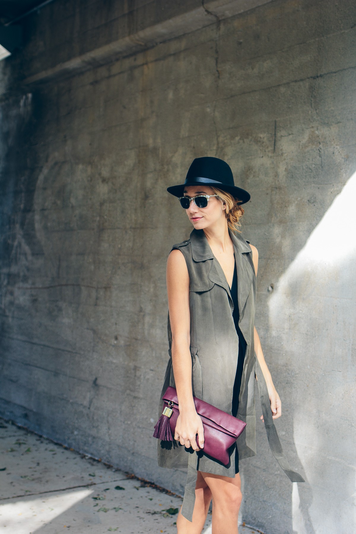 trench vest, wool hat, carmen clutch with tassel detail — via @TheFoxandShe