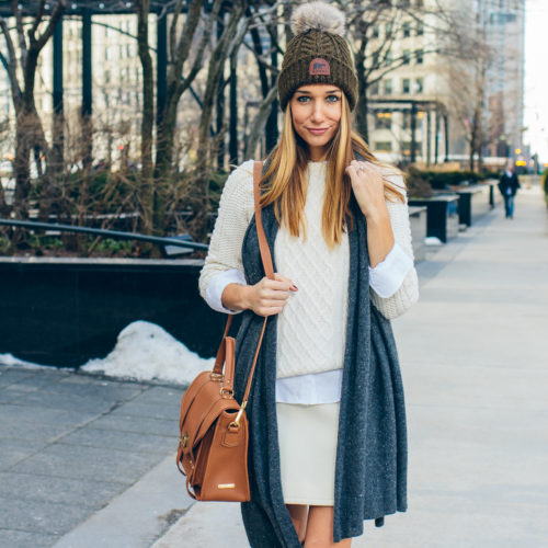 winter whites, camel bag, cable knit sweater, pom pom beanie — via @TheFoxandShe