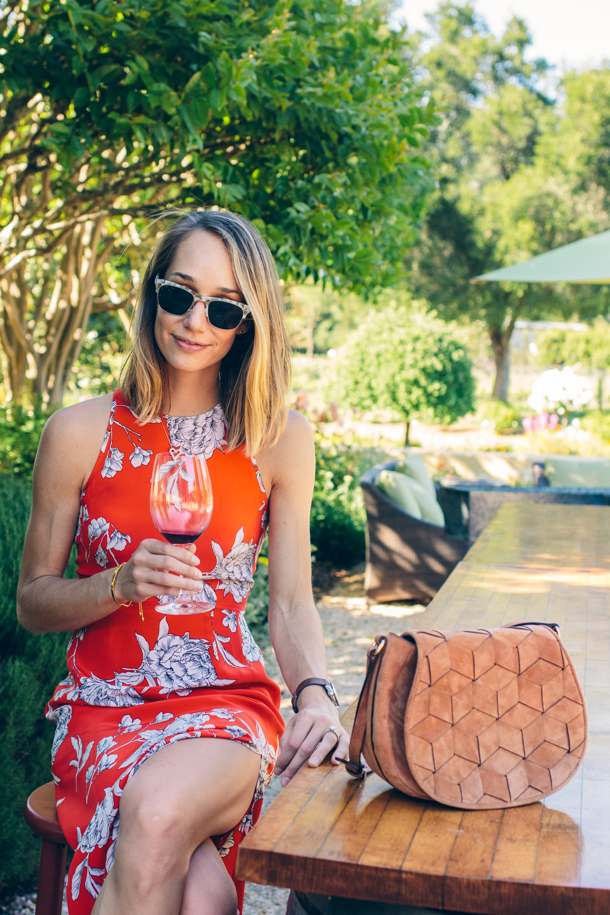 red floral dress, woven bag — via @TheFoxandShe