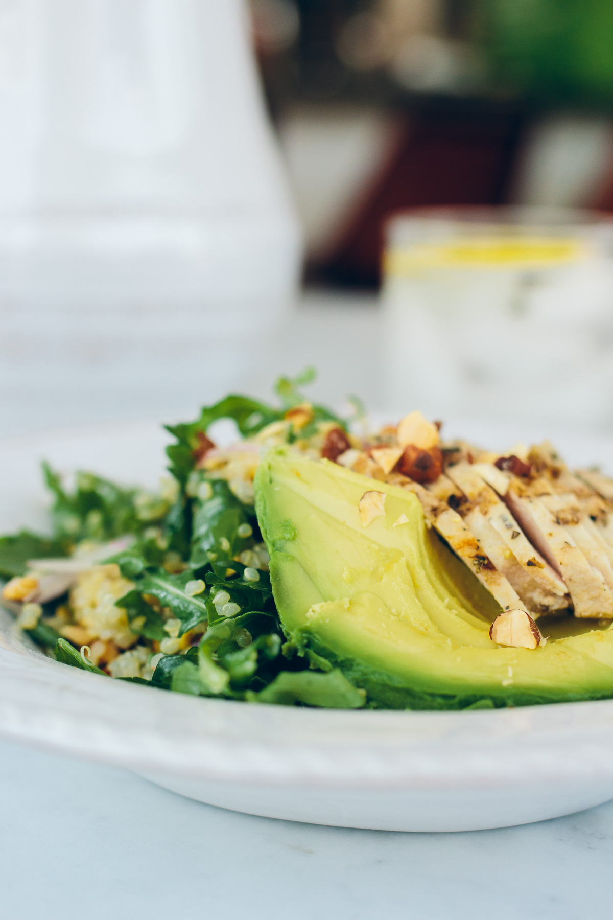 healthy quinoa and arugula salad with avocado and chicken
