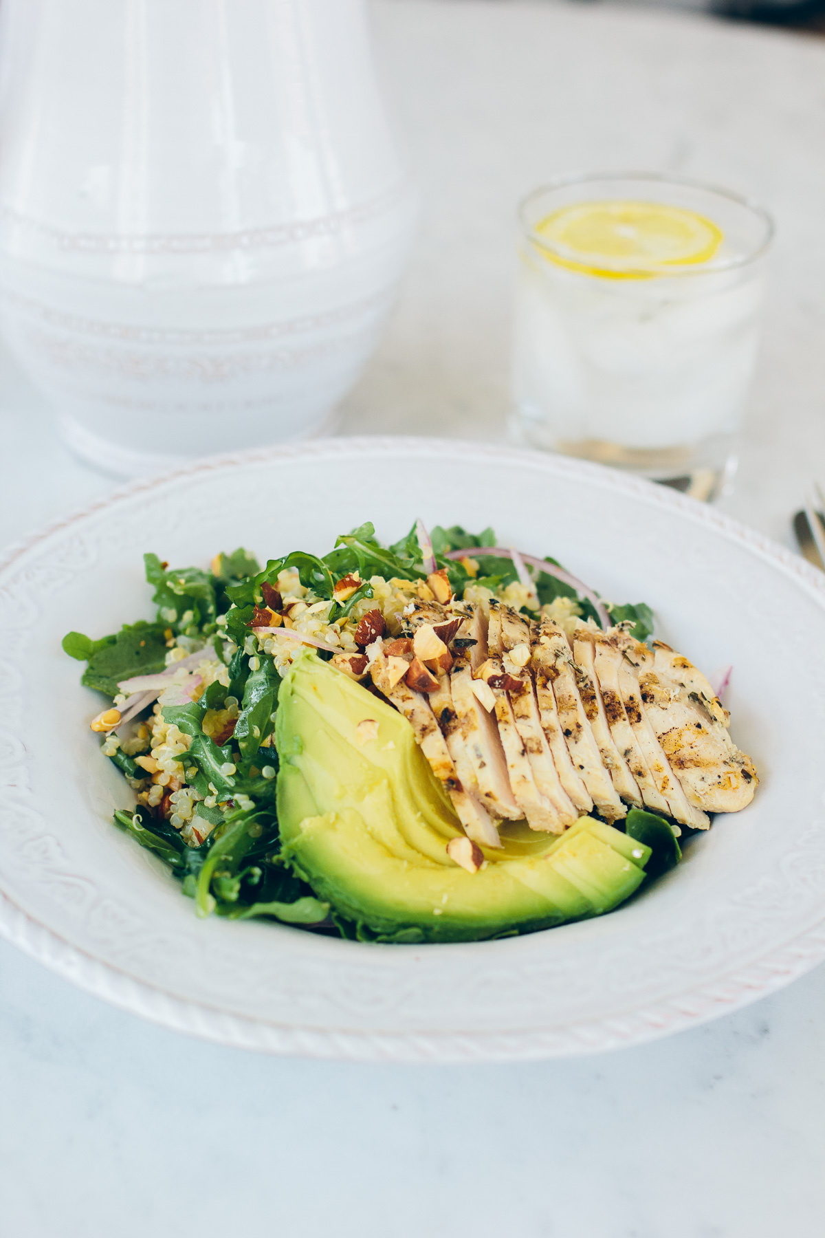 healthy quinoa and arugula salad with avocado and chicken