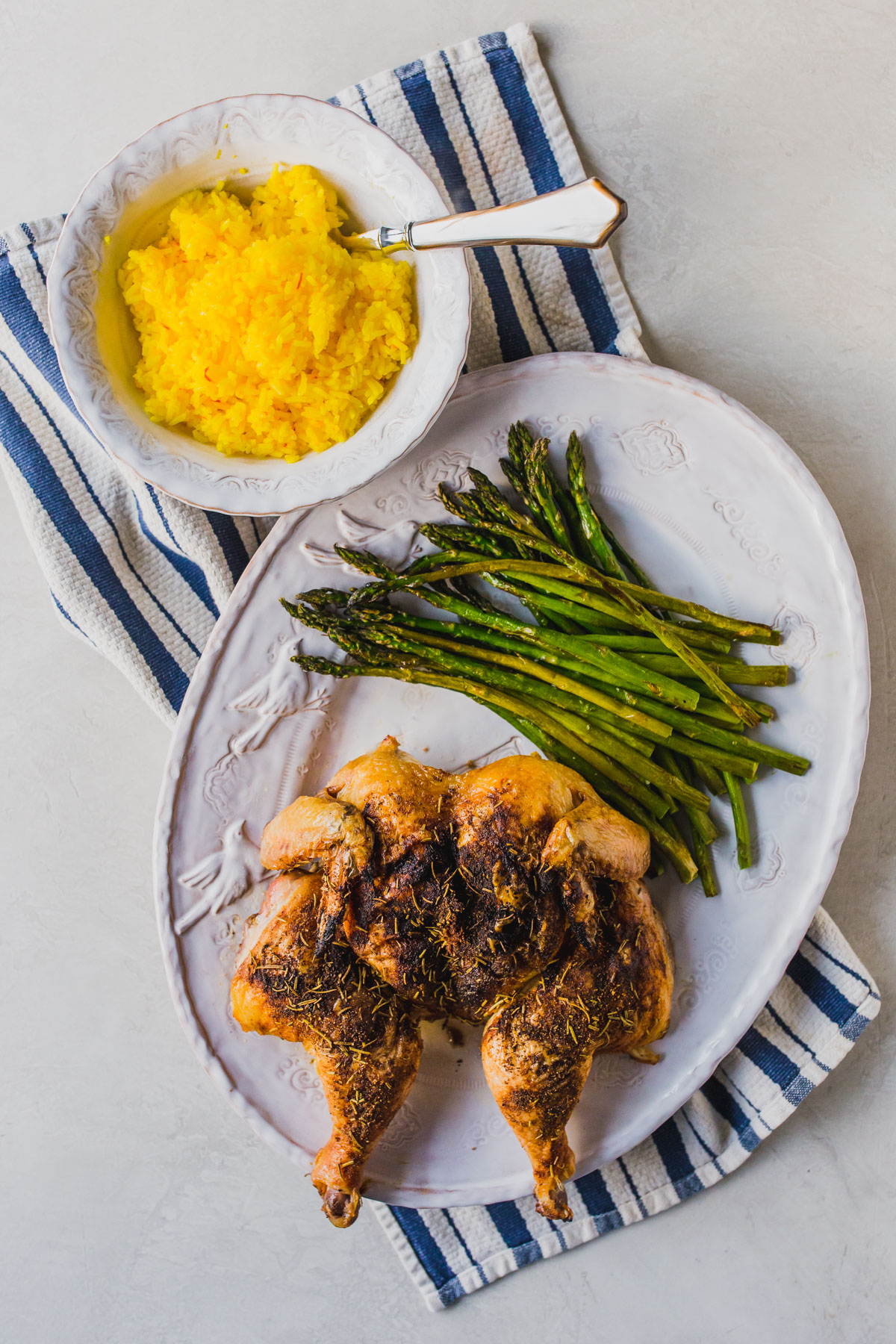This easy oven roasted whole chicken is a perfect healthy dinner recipes for the family. I served it with easy saffron rice and oven roasted asparagus to keep the ingredients to a minimum. You probably already have the spices in your pantry too! Make easy homemade chicken stock from the bones for a a no waste recipe! Click through for the recipe for this whole roasted chicken with vegetables. #healthydinners #easydinnerideas