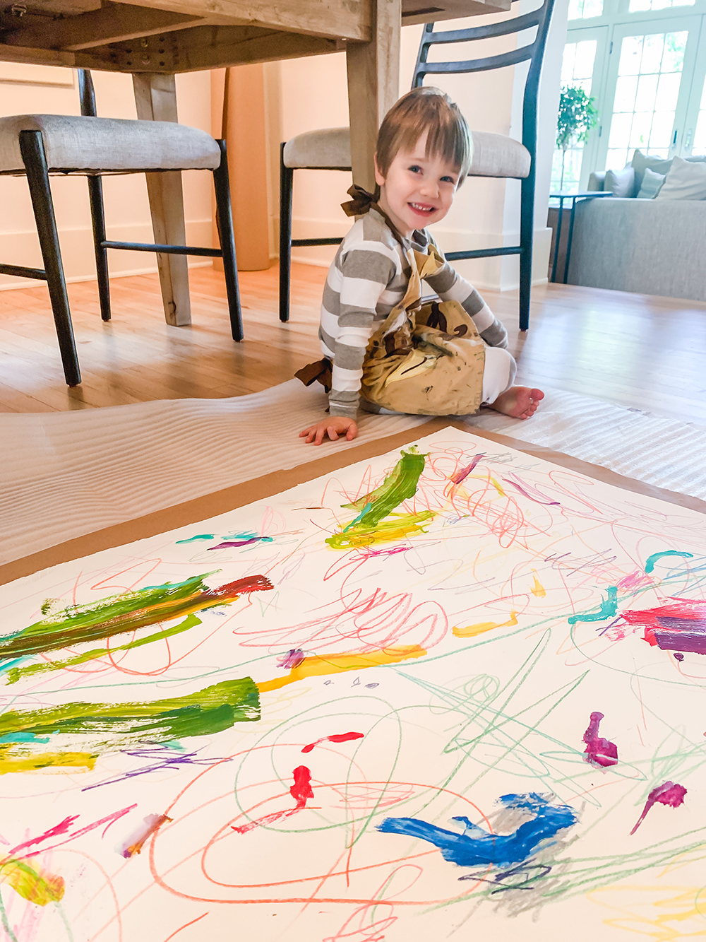 child under the table and coloring a big sheet of paper child under the table and coloring a big sheet of paper for one year can make