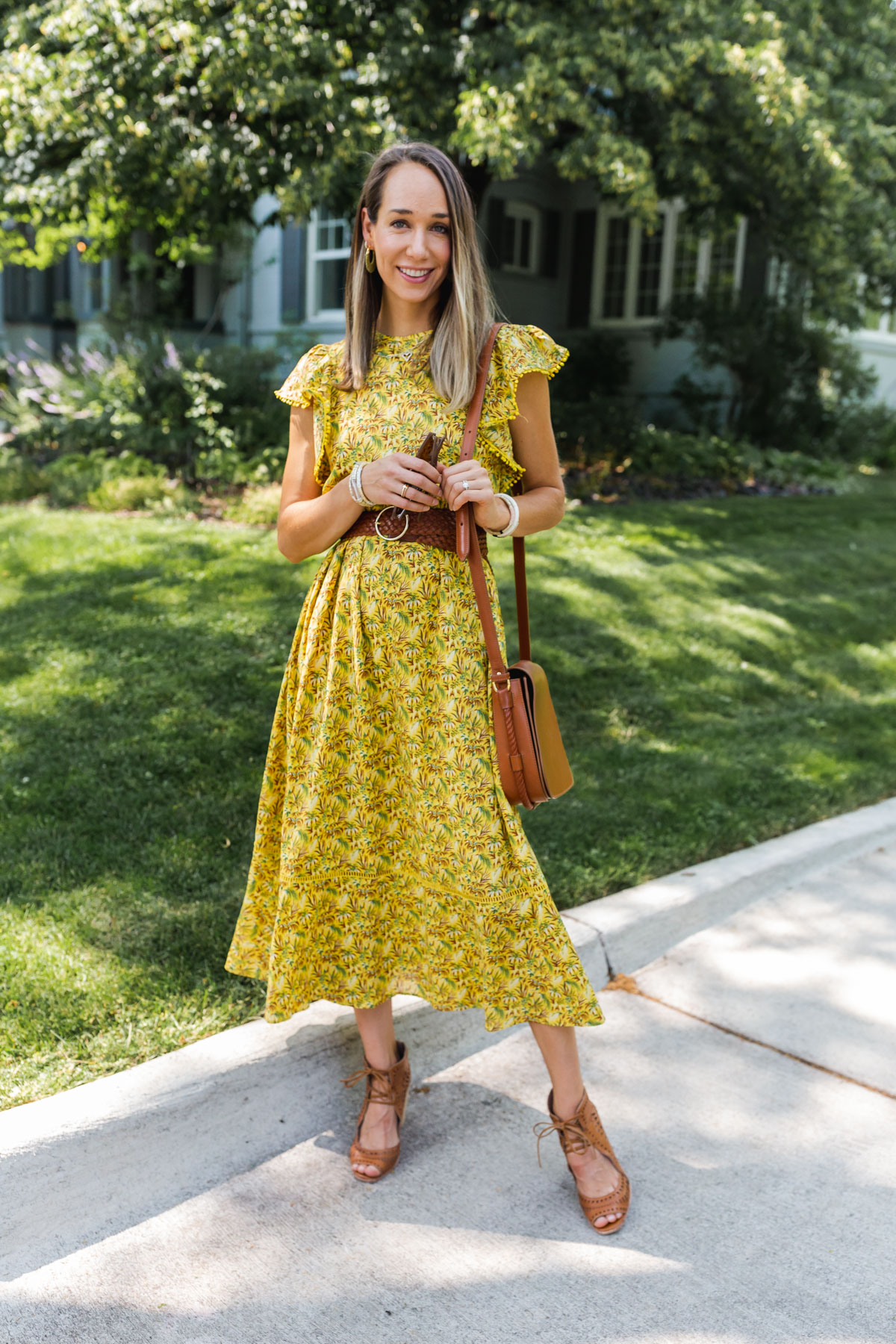 woman wearing yellow dress for what to wear to a baby shower