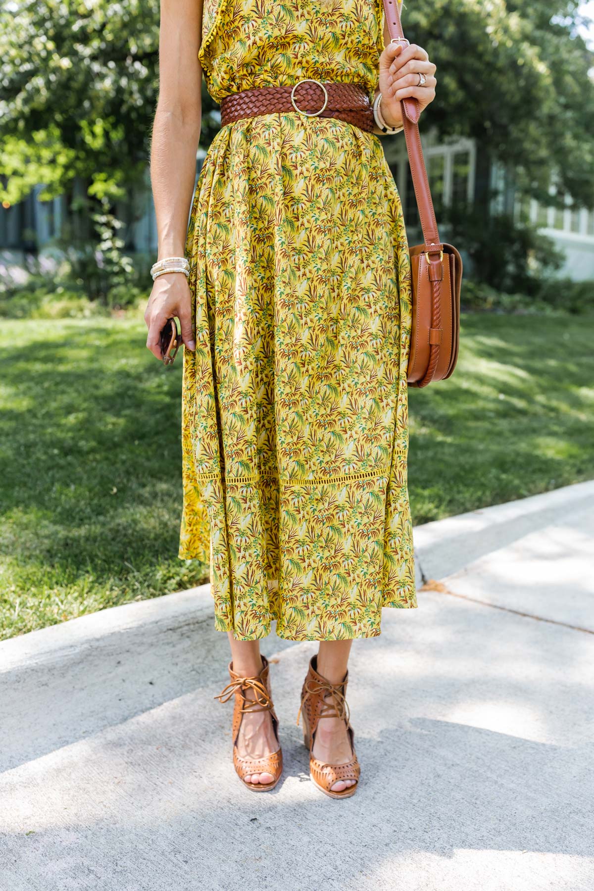 woman wearing printed dress and nude platform sandals